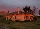 House 18 at dusk, kitchen to the left, livingroom at right